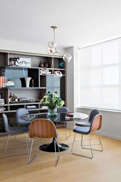 409551-Danish_chairs_with_wool_covered_seats_surround_an_Eero_Saarinen_table_in_the_dining_area_