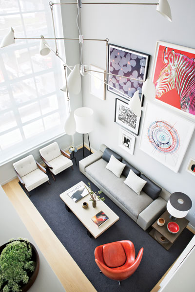 409555-Beneath_the_living_area_s_20_foot_ceiling_stand_a_sofa_covered_in_linen_and_horsehair_and_a_linen_wrapped_cocktail_table_both
