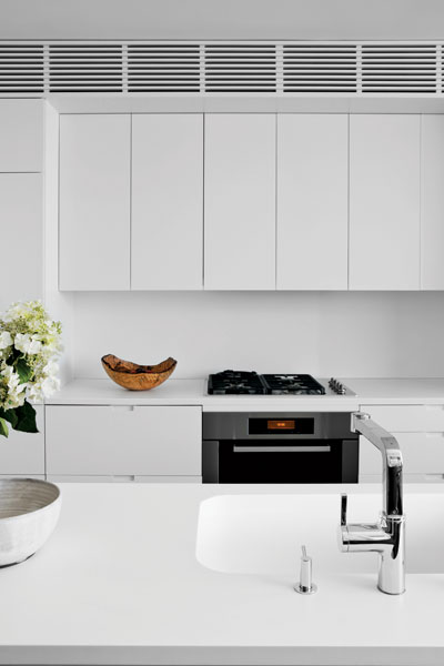 409556-The_kitchen_s_island_stands_opposite_from_custom_cabinets_of_lacquered_plywood_